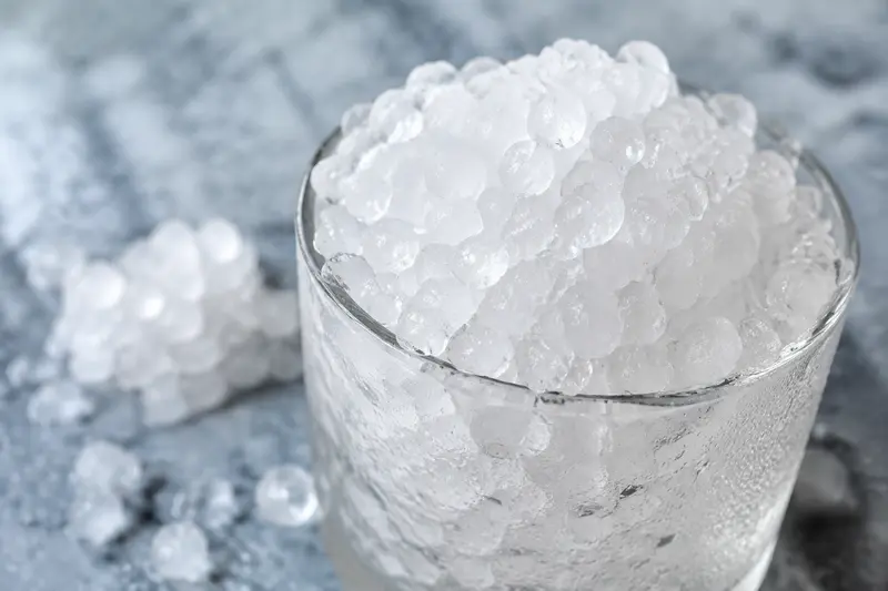 Close-up of generic soft pebble-shaped nugget ice in a cold glass
